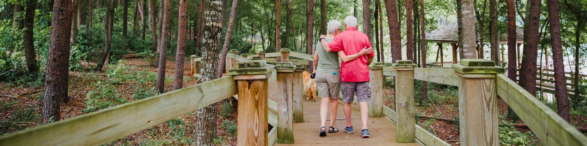 Residents walking a wooded trail